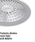 Close-up of stainless steel bathtub drain protector with hair catcher for quick clog prevention, showing holes and silicone rim.