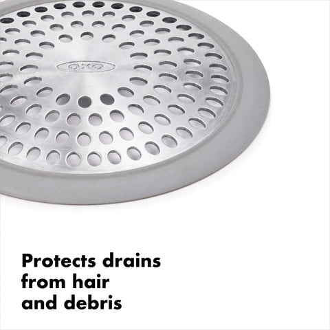 Close-up of stainless steel bathtub drain protector with hair catcher for quick clog prevention, showing holes and silicone rim.