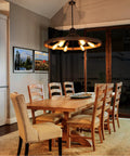 31.5 Inch Farmhouse Chandelier With Rustic Wagon Wheel Silhouette in Vintage Rust and Black Finish over dining table