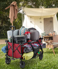 Heavy Duty Collapsible Outdoor Utility Wagon With Oversized 36 By 21 By 15 Bed And 150 Pound Capacity Red Foldable Rolling Cart With Cup Holders And Pockets For Beach Camping Sports Or Picnics loaded with camping gear in front of a tent.