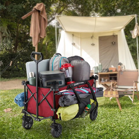 Heavy Duty Collapsible Outdoor Utility Wagon With Oversized 36 By 21 By 15 Bed And 150 Pound Capacity Red Foldable Rolling Cart With Cup Holders And Pockets For Beach Camping Sports Or Picnics loaded with camping gear in front of a tent.