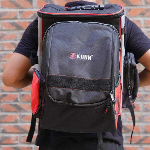 Person carrying Welding Backpack With Detachable Helmet Bag And Built In Lunch Tote For Easy On The Job Site Storage Of Welding Gear Ultra Durable Tool Carrier With Padded Back And Straps Red