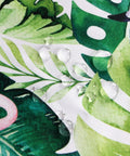 Close-up of waterproof outdoor 60 inch square tablecloth with umbrella hole and zipper, showing green leaf pattern on polyester fabric