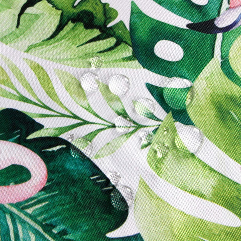 Close-up of waterproof outdoor 60 inch square tablecloth with umbrella hole and zipper, showing green leaf pattern on polyester fabric