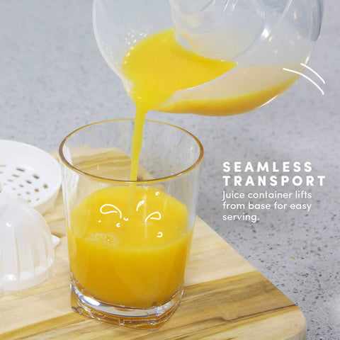 Elite Gourmet Compact Electric Citrus Juicer In White 30 Watt With 16 Oz Capacity for fresh orange juice pouring into a glass.