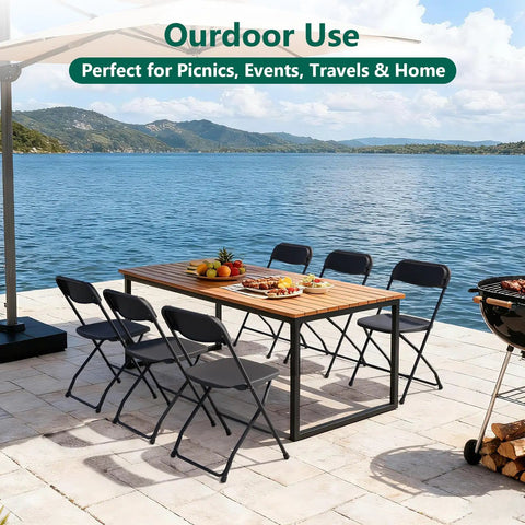 Outdoor use with 4 Pack Black Plastic Folding Chairs With Steel Frame For Outdoor Use No Fuss Portable Stackable Foldable Seating 350 Lb Capacity For Patio Garden Picnic Kitchen Events shown around a wooden table on a lakeside patio.