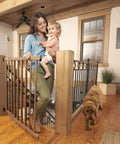 Woman and child using Walk-Thru Top Of Stairs Baby Gate Farmhouse Collection Expands From 30 To 48 Inch Openings, 32 Inch Tall
