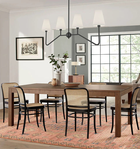 47 Inch Four Light Linear Kitchen Island Pendant In Matte Black With White Linen Shades over wooden dining table