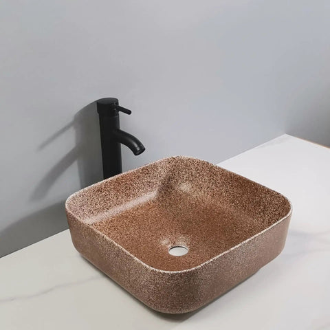 Bathroom Sink Bathroom Sink Modern Art Basin Hotel Apartment Bathroom Wash Basin Square Above Counter Basin Home Bathroom Wash Basin Bathroom Sink Vessel in brown finish on countertop.