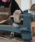 No Nonsense Heavy Duty 4 Inch Steel Wood Lathe Faceplate With 1x8TPI Spindle in use on a lathe with a woodturner shaping a workpiece.