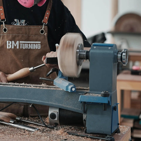 No Nonsense Heavy Duty 4 Inch Steel Wood Lathe Faceplate With 1x8TPI Spindle in use on a lathe with a woodturner shaping a workpiece.