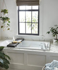 Elmhurst Roman Tub Trim Kit Chrome For 3 Hole 8 To 16 Inch Installations ADA compliant, shown in a modern bathroom setup
