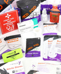 Lightning X first aid supplies assortment with gloves, towelettes, burn gel, dressings, and a red First Aid guide.