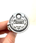 Hand holding Coin-Style Spark Plug Gap Tool For Quick Checks, 0.020-0.100 In Gap Range, Plated Steel Build, Pro Grade Gauge