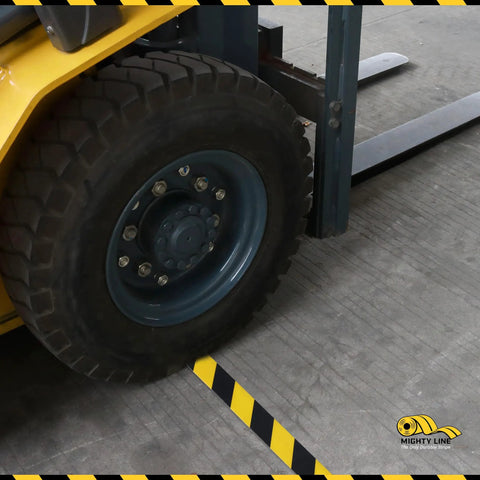 Forklift wheel on Built Like A Rock 5S Floor Marking Tape Yellow 6 Inch Wide 100 Foot Roll Heavy Duty Industrial Beveled Edge.
