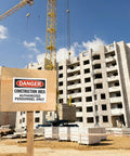 Danger Construction Area Authorized Personnel Only OSHA Sign at a construction site, building in background, 9x12 inch sign visible.