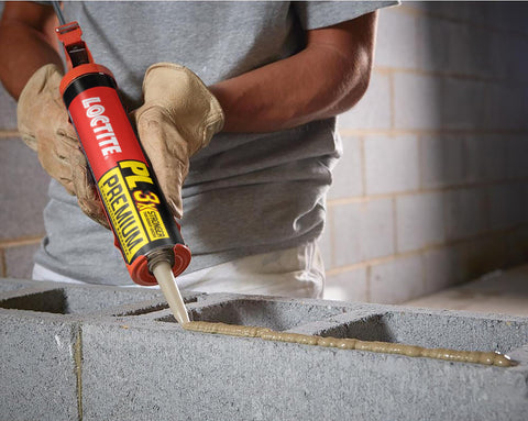 Person applying Premium Polyurethane Construction Adhesive 10 Fl Oz Cartridge 1 Pack 3X Stronger Bond on concrete blocks