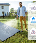 Man watering lawn with 50 Pack Interlocking Drainage Mats 10 By 10 Inch Rubber Floor Tiles for outdoor use shown in garden