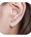 Implant Grade F136 Titanium Dot Stud Earrings Featuring Secure Screw Back Flat Posts, shown in three sizes on ear.