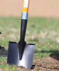 Heavy Duty Digging Shovel 41 Inch With Trenching Blade And Comfortable Handle shown in garden soil use