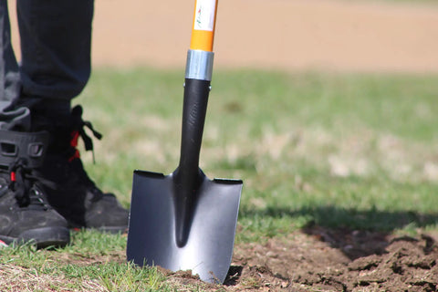 Heavy Duty Digging Shovel 41 Inch With Trenching Blade And Comfortable Handle shown in garden soil use