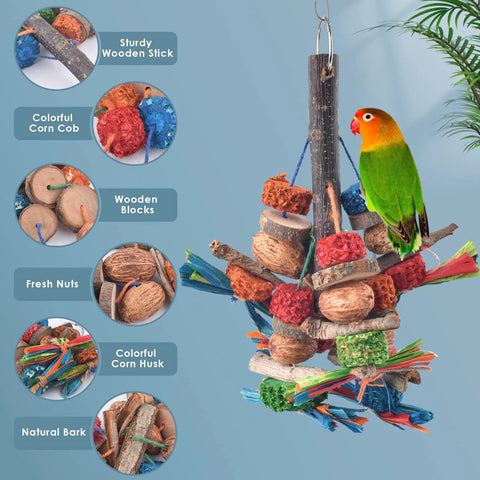 Hella Tough Parrot Chew Toys Crafted From Natural Wood Hemp Rope Corn Cob And Sweet Treat Nuts For Big Time Foraging Fun In Conure Cockatoo Parakeet Budgie Cage, featuring colorful pieces and a green bird on a hanging toy.