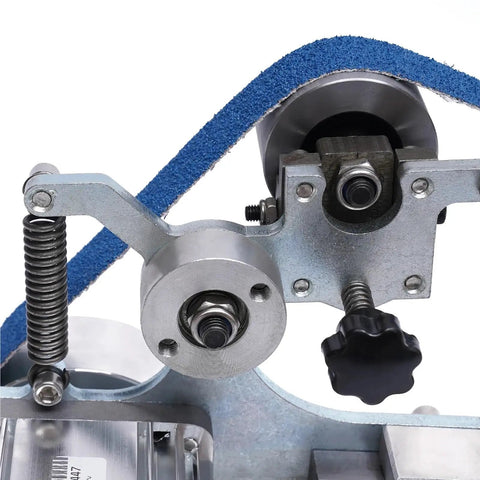 Close-up of Straight Up Solid Desktop Belt Sander Kicking Five Fifty Watts For Polishing And Grinding parts and mechanisms.
