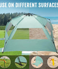 Deluxe XL Pop Up Beach Tent Sun Shade For 3 To 4 People With UV Protection on sand and grass surfaces, mint green color.