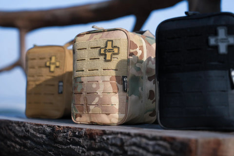 Rhino Rescue IFAK tactical first aid MOLLE pouch, front view; three pouches shown: camo center, tan left, black right.