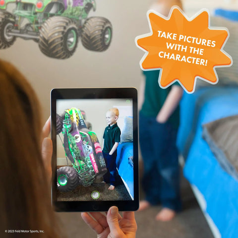 Child using Grave Digger Monster Jam wall decal with 3D augmented reality interaction in bedroom, tablet shows AR character.