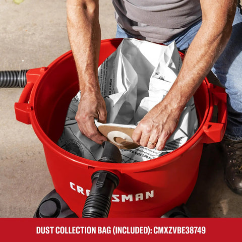 Man fitting dust collection bag into 16 Gallon 6.5 Peak HP Wet Dry Shop Vacuum With Built In Blower Port for garage cleanup