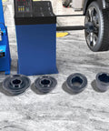 Universal Wheel Balancer Taper Cone Set Four Piece Kit Made From Heavy Duty Carbon Steel on a workshop floor.