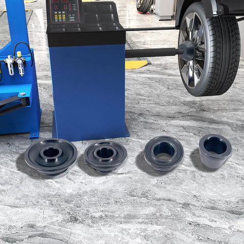 Universal Wheel Balancer Taper Cone Set Four Piece Kit Made From Heavy Duty Carbon Steel on a workshop floor.