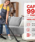Woman vacuuming with a yellow HEPA vacuum cleaner, efficiently capturing dust and fine particles in a living room setting.