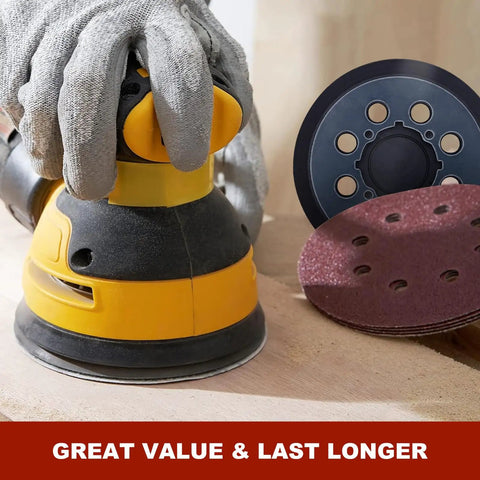 Hand holding a DeWalt sander with 52 Piece Sander Pad And Discs Combo Kit With 2 Pack 5 Inch 8 Hole Hook And Loop Pads And 50 Sanding Discs.