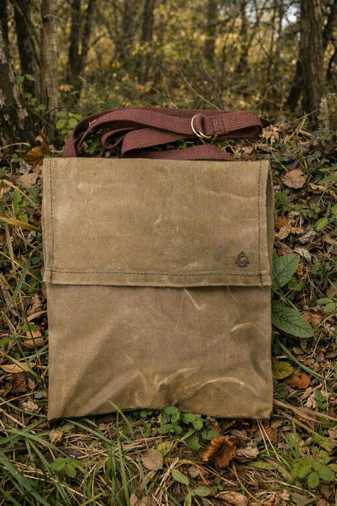 Waxed Canvas Haversack With Adjustable Strap for Outdoor Adventures 11 by 14 Inches Fits From Small to 5XL in a forest setting