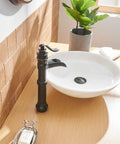 Oil Rubbed Bronze Vessel Sink Faucet Tall Waterfall With Single Handle One Hole Installation Solid Brass Vanity Lavatory RV Bathroom Faucet For Bathroom Sink next to a round white basin on wooden countertop