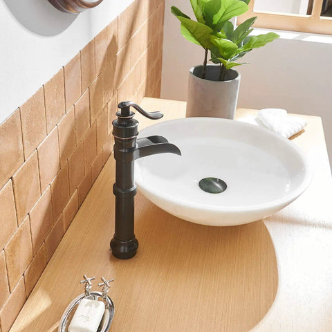 Oil Rubbed Bronze Vessel Sink Faucet Tall Waterfall With Single Handle One Hole Installation Solid Brass Vanity Lavatory RV Bathroom Faucet For Bathroom Sink next to a round white basin on wooden countertop