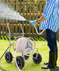 Person using Heavy Duty Hose Reel Cart For 250 Ft Of 5/8 Inch Hose, Grab-And-Go Garden Water Cart With 4 Wheels, Powder Coated Steel