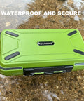 Green floating double sided fishing tackle box with adjustable dividers floating in water, suitable for organizing small items.