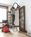 Person using All Purpose Wet Dry Vac Attachment Kit For Home And Shop Use, Industrial Grade Vacuum Accessories with ladder and hose.