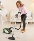 Woman using Heavy Duty Plastic Cyclone Dust Separator With Adapter For Vacuum Systems, cleaning debris from floor.