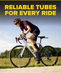 Cyclist riding a road bike, highlighting Inner Tube For 700x35 To 700x43c And 28 Inch Wheels With 37mm Schrader Valve Butyl Rubber 2 Pack
