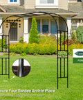 7.9 Foot Metal Garden Arch Trellis For Outdoor Climbing Plants, Large Wedding Ceremony Arbor shown in a garden setting