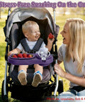 Smiling toddler in stroller with 3 In 1 Modular Stroller Snack Tray With Universal Fit Dual Lock Attachment For Strollers Shopping Carts Joggers And Bugaboo Includes Three Separate Silicone Bowls And Cup Holder A Smart On The Go Feeding Hack For Parents, holding a strawberry.