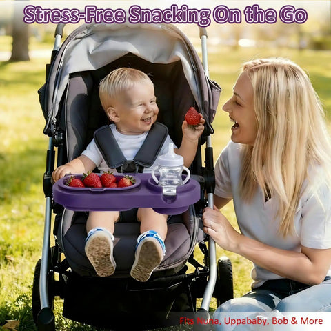 Smiling toddler in stroller with 3 In 1 Modular Stroller Snack Tray With Universal Fit Dual Lock Attachment For Strollers Shopping Carts Joggers And Bugaboo Includes Three Separate Silicone Bowls And Cup Holder A Smart On The Go Feeding Hack For Parents, holding a strawberry.