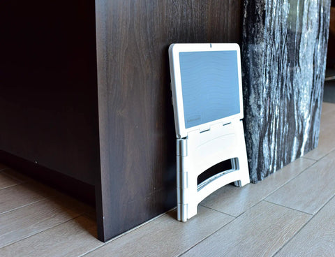 Grab And Go Ultra Compact Mini Folding Step Stool Lightweight 2.5 Lb design leaning against wall, collapses under 1 inch, white.