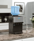 Limited Edition Top Loading Countertop Water Cooler Dispenser With On Demand Hot Cold And Room Temperature Water Tri Temp UL And Energy Star Approved Stainless Steel Reservoirs Kid Safe Lock on kitchen counter