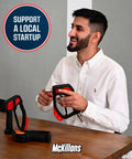 Person holding a McKillans product at a table with "Support a Local Startup" sign in the background.