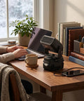 Portable Battery Powered Space Heater With Dual Usb Charging And Two Adjustable Temp Levels For Kickin Quiet Warmth Featuring A 360 Degree Rotating Head Perfect For Office Desks Or Dorm Setup Vibes on a wooden desk with coffee and laptop.